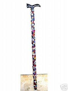 an old style walking stick with colorful designs on it