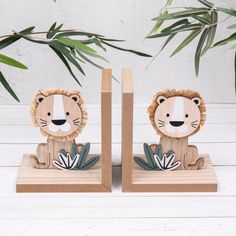 two wooden lion figurines sitting next to each other on top of a table