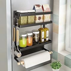 a bathroom shelf with two rolls of toilet paper and some spices on it next to a potted plant