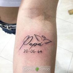 a person with a tattoo on their arm that reads papai and has two doves