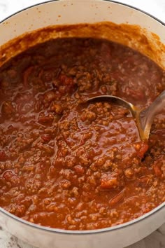 a large pot filled with chili and meat