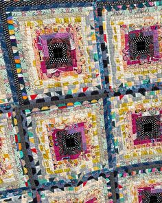 a close up of a quilt with squares and circles on the center, as if it were made out of fabric