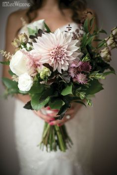 a bride holding a bouquet of flowers in her hands