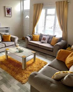 a living room filled with furniture and yellow accents