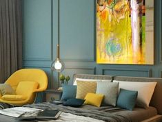 a bedroom with blue walls and yellow chairs on the bed in front of a chandelier