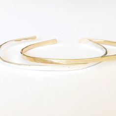 Our "Charlie" bangle with initials is understated, delicate and simple. Perfect for you or a gift for someone special. - Initials at each end of the bangle make it extra special. You can add a first and last initial. - We make these by hand so each one has its very own personality - One size fits most - A 6.5 inch bracelet with 1 inch opening that can be squeezed open or closed - Please message us at hello@sarahcornwelljewelry.com if you need a custom size. - all pieces are Sterling Silver or 14 Classic Hammered Bracelets As Gift, Classic Hammered Bracelets For Gifts, Classic Hammered Bracelets For Gift, Minimalist Hammered Bracelets For Anniversary, Minimalist Hammered Cuff Bracelet As Gift, Minimalist Adjustable Bangle For Anniversary, Minimalist Hammered Cuff Bracelet Gift, Minimalist Gold Cuff Bracelet In Sterling Silver, Minimalist Hammered Bangle As Gift