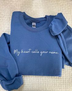 My heart calls your name - King George sweatshirt. This is a Queen Charlotte: A Bridgerton Story inspired sweatshirt, this sweatshirt can also be known as a Bridgerton sweatshirt or even Bridgerton merch. This show and book inspired sweatshirt is so cute to wear out!  FREE SHIPPING  The design size is 9.8 inches wide and 1.6 inches in height! Please allow up to 1-3 business days for the product to be made. * 50% cotton, 50% polyester * Pre-shrunk * Classic fit * 1x1 athletic rib knit collar with spandex * Air-jet spun yarn with a soft feel and reduced pilling * Double-needle stitched collar, shoulders, armholes, cuffs, and hem 10% of profits are donated to nonprofit organization. CARE instructions: Machine wash warm, inside out (to protect the embroidery), with like colors. Tumble dry-low. Bridgerton Embroidery, Aunt Sweater, Aunt Shirts, Queen Charlotte, Comfort Colors Sweatshirt, Girl Reading, Black Thread, Aunt Gifts, Funny Sweatshirts