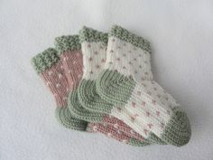 three knitted mittens laying on top of each other