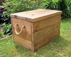 a wooden box sitting on top of a lush green field