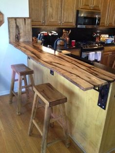 a kitchen island made out of wood with two stools