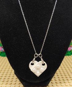 Custom handmade Heart Necklace made with genuine Lego® pieces. The Lego® heart clips on to two lobster clasps making it easy to change out the color of the heart. The two Lego® pieces are not glued together making it easy to swap one piece out with another color and making it a two color heart. The necklace chain is 20” long and 1.2mm thick with a lobster clasp. The silver plated iron makes for a shiny yet sturdy necklace. Vegas Brick Couple LLC is not affiliated with LEGO®. This product is fan Lego Couple Keychain, Matching Lego Heart Necklace, Matching Lego Keychain, Matching Lego Necklace, Lego Heart Necklace, Lego Heart, Lego Necklace, Color Heart, Lego Pieces