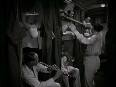 an old black and white photo of some people playing musical instruments in a train car