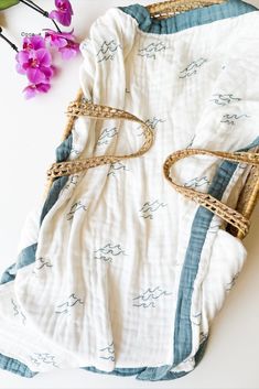 Super cute organic muslin blanket. Perfect for little surfer and ocean nursery decor! Made from organic bamboo and cotton with blue trim.