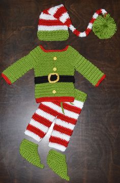 a crocheted christmas outfit and hat on a table