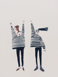 two people with their arms in the air and one holding his head up, both wearing striped sweaters