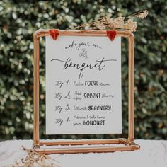 a sign that has been placed on top of a table with flowers in the frame