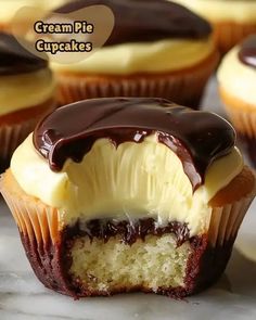 cupcakes with cream and chocolate frosting on top