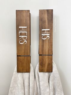 two wooden blocks with white writing on them sitting on top of a pair of gloves