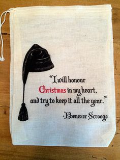 a tea towel with an image of a hat on it and the words i will honur christmas in my heart, and try to keep it all the year