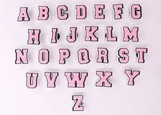 the letters and numbers are made out of pink plastic material with black lettering on them