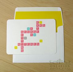 an envelope with a crossword card on it sitting on top of a wooden table