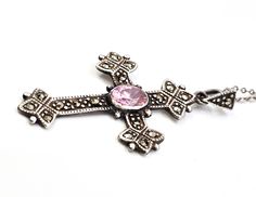 Marcasite and pink cubic zirconia cross CZ sterling silver pendant necklace. Good used condition with little to no signs of normal wear. No missing stones. Stamped TH 925 on the back of the cross. Comes with sterling silver necklace. Acid tests positive for sterling silver. Gemstones tested with Presidium II gemstone tester. Necklace measures 18 inches long. Pendant measures 1 inch wide and 1 and 5/8ths of an inch tall. Pink Cross Necklace For Gifts, Pink Cross Necklace For Gift, Pink Sterling Silver Cross Jewelry, Pink Cross Sterling Silver Jewelry, Sterling Silver Necklace Pendants, Long Pendant, Silver Pendant Necklace, The Cross, Sterling Silver Necklace