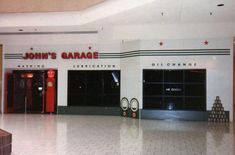 the entrance to john's garage in an empty shopping mall with no people on it