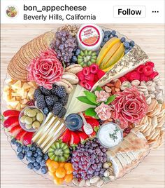 a platter filled with assorted fruits and cheeses