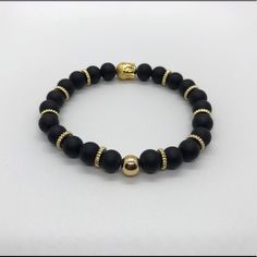 Gold Buddha And Black Beads Combination Creating A Great Piece Of Jewelry For Any Occasion Adjustable Black Onyx Bead Stretch Bracelet, Adjustable Onyx Stretch Bracelet With Black Beads, Adjustable Onyx Beaded Bracelets, Black Stretch Bracelet With Spacer Beads As Gift, Black Bracelets With Spacer Beads As Gift, Black Bracelets With Spacer Beads For Gift, Adjustable Black Stretch Bracelet With Spacer Beads, Adjustable Black Beaded Rosary Bracelet, Casual Gold Beaded Bracelets For Party