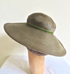 "Rare olive green shade hat of fine woven straw from the late 1940's to 1950's. Rounded crown and a wide down turned brim with encased wire around the outside edge. Trimmed with an ivory/creme silk rose and leaf brooch as well as green velvet ribbon and bow at the lower crown. Interior crown is trimmed with olive green grosgrain ribbon. Label: Knickerbocker, Fashion Center from Washington DC Condition: Excellent. Looks barely worn if at all. Size/Measurements: crown height- 2\" brim diameter- 16 Vintage Wide Brim Straw Hat For Evening, Green Brimmed Straw Hat For Garden Party, Vintage Green Hat For Wedding, Green Wide Brim Straw Hat For Garden Party, Vintage Green Wedding Hat, Vintage Curved Brim Straw Hat For Church, Green Curved Brim Straw Hat For Garden Party, Green Straw Hat With Curved Brim For Garden Party, Vintage Green Adjustable Hat