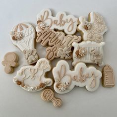 some cookies that are laying on a table with the words baby spelled out in them