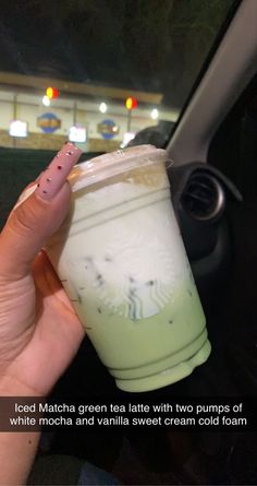 a person holding up a drink in their hand with the caption, iced matcha tea latte with two pumps of coffee