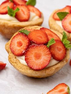 strawberry shortcakes with whipped cream and fresh strawberries on the top are ready to be eaten