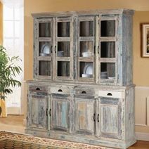 an old china cabinet with glass doors and drawers in the middle of a living room