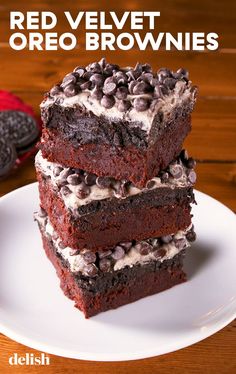 three red velvet oreo brownies stacked on top of each other with chocolate chips