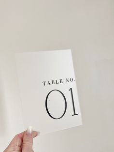 a person holding up a table number card with the numbers 10 and 11 on it