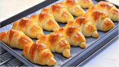 there are many croissants on the baking sheet