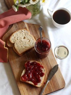 two slices of bread on a cutting board with jam