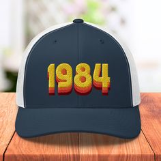 DESIGN Bring it back to the 80s with this retro, nostalgic 1984 design hat. Perfect for that retro 40th birthday party! DELIVERY TIMES / INFORMATION It takes 2-5 days to produce and fulfill hat orders at a fulfillment center based on your shipping destination. Tracking information will be sent to your inbox when your order is on its way. Typical time from ordering to receiving your hat order (in business days): ✅US: 6-9 Days ✅Canada: 7-10 Days ✅UK: 7-12 Days ✅Worldwide: 7-15 Days We ship interna Retro Letter Print Baseball Cap, Retro Cap Hat As Gift, Retro Snapback Hat As Gift, Vintage Adjustable Hats For Birthday, Custom Embroidered Hats, Back To The 80's, 80s Aesthetic, Trendy Hat, Hat Custom