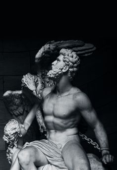 a black and white photo of a statue of a man with an angel on his back