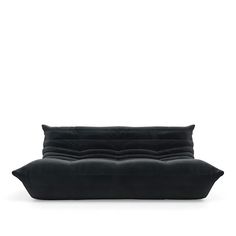 a black pillow sitting on top of a white surface