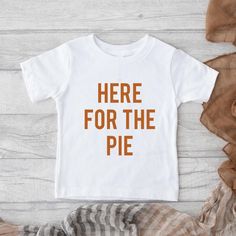 "Here for the pie" shirt. The shirt features premium quality materials and vibrant colors. Shirt Details: * Rabbit Skins brand fine jersey * Color: Natural or White * Avilable in Infant Onesie or Tshirt * 100% Combed ringspun cotton * Classic fit * Wash in cold and hang to dry Thanksgiving Shirts For Kids, Pie Thanksgiving, Harvest Pumpkin, Thanksgiving Shirt, Fall Kids, Thanksgiving Shirts, Fall Shirt, Baby Boutique, Fall Shirts