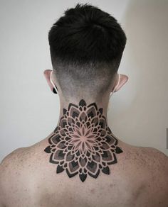 the back of a man's neck with a tattoo design on his neck and chest