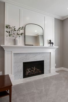 a living room with a fireplace and mirror