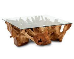 a glass table that has some kind of tree stump on it and is made out of wood