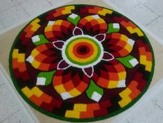 a circular rug with an abstract design on the floor in front of a tiled floor