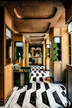 an instagramted photo of a hotel hallway with black and white checkerboard flooring