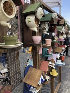 a bunch of bird houses that are on display