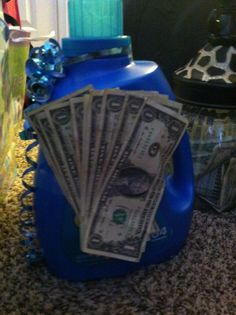 a blue container with money sitting on top of it