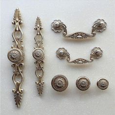 an assortment of antique silverware including handles, knobs and drawer pulls from the early 20th century